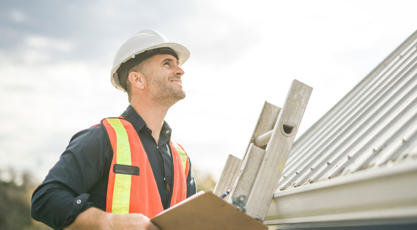 Roofer inspecting a roof for signs of a leak