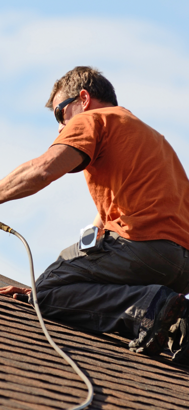 Roofer performing roof maintenance