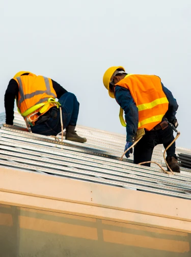 Roofers repairing a residential roof