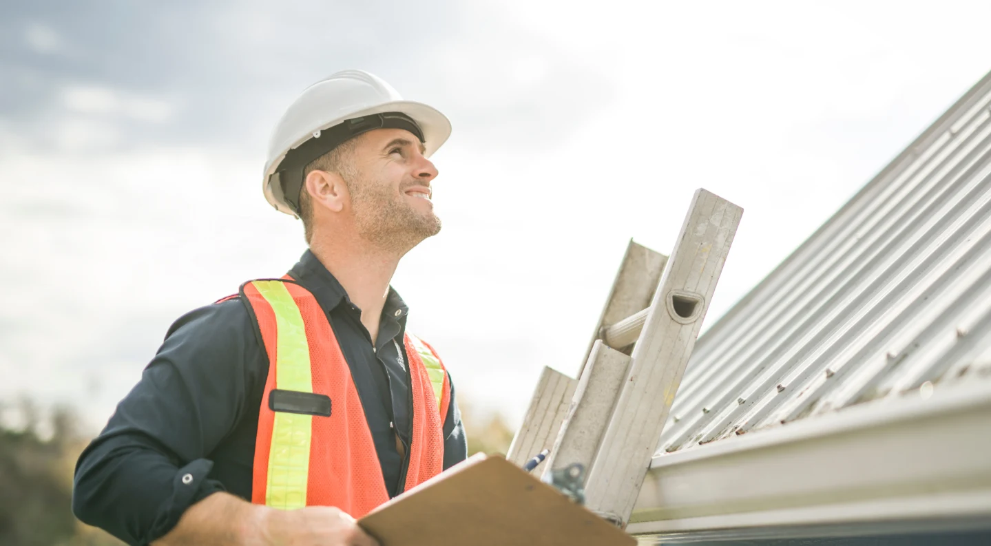 Roofer inspecting a roof for signs of a leak