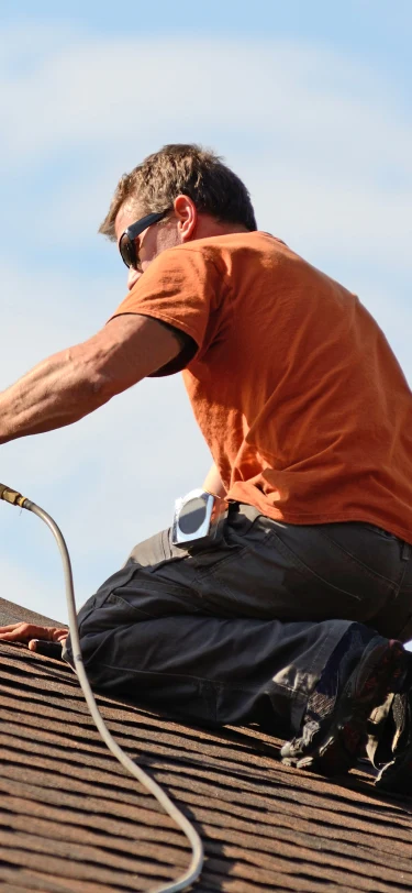 Roofer performing roof maintenance